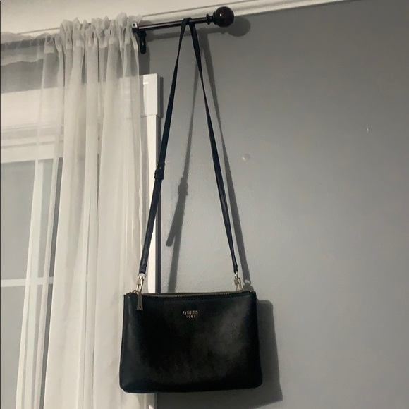A black and silver authentic GUESS crossbody